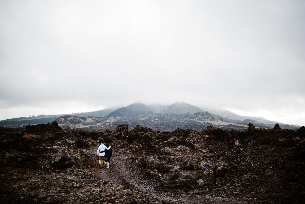 Pre wedding spot in Batur Mountain View with the couple walking in the black lava kintamani
