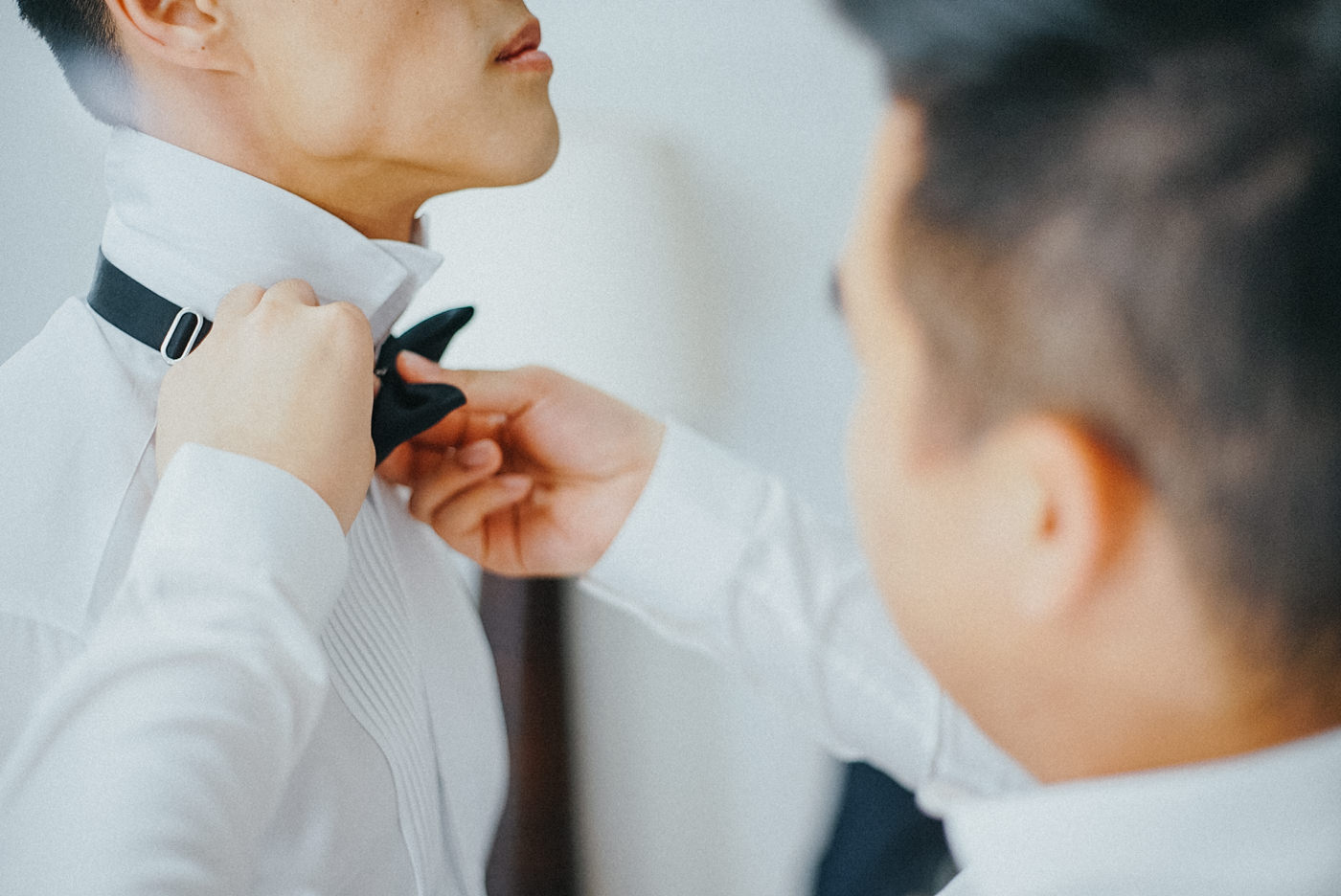 Tying the Bow Tie on a wedding at ayana bali