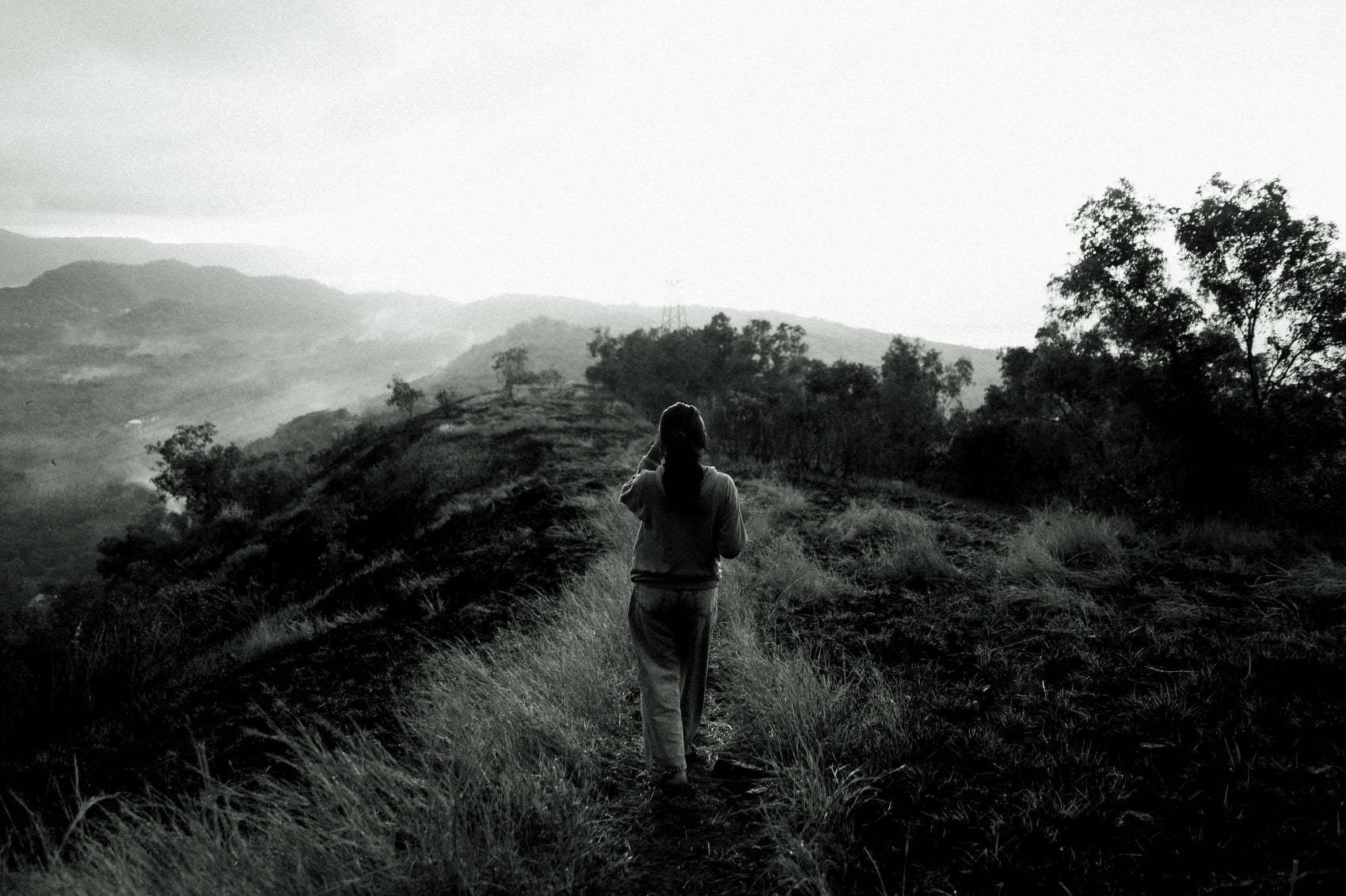 A girl walk by in the Bukit Tengah grassland.