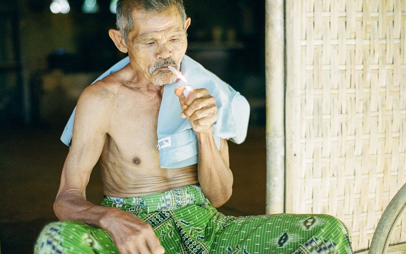 an old man light a cigarette