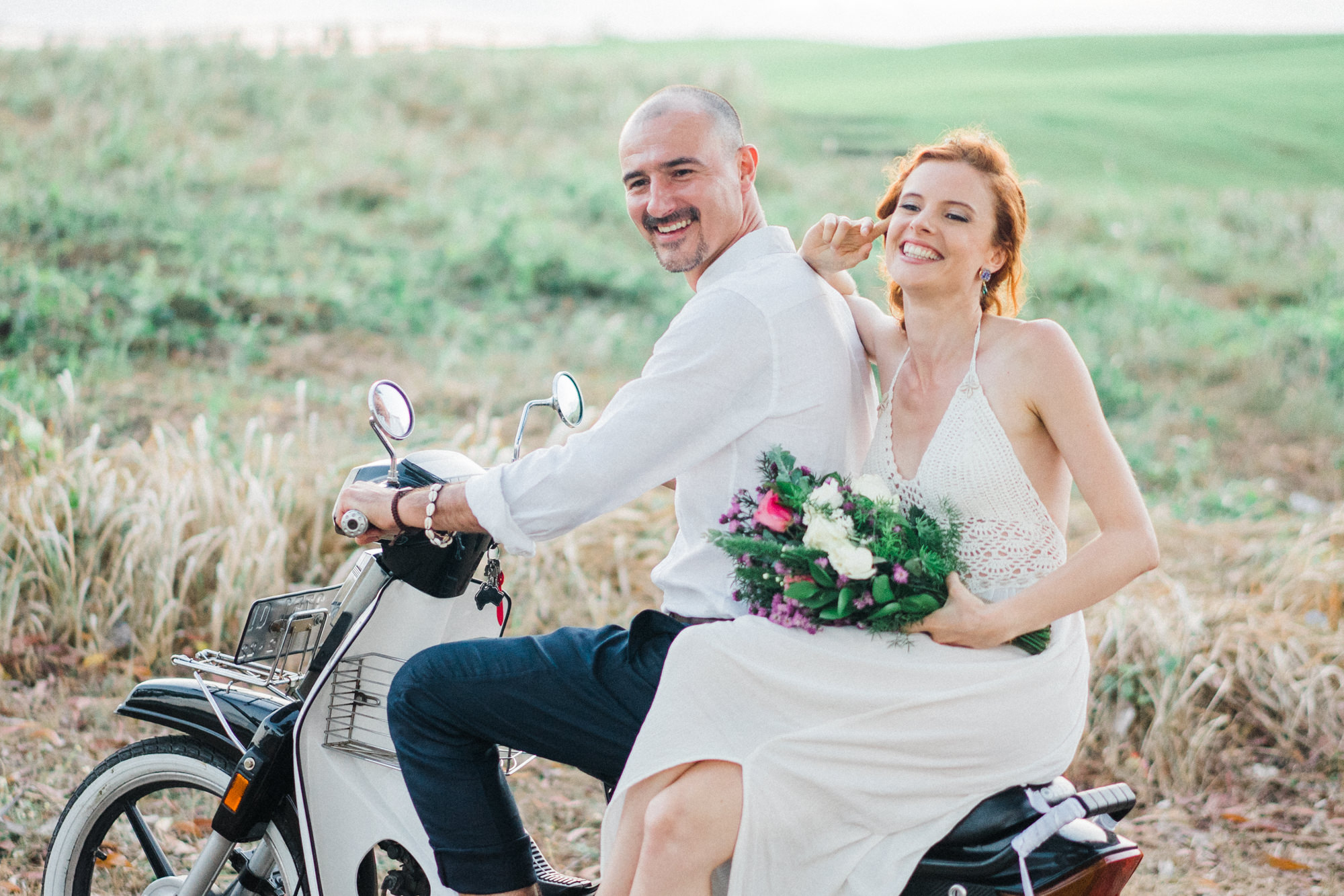 Lucyna and Kuba riding motorbike during their Bali elopement in New Kuta Golf