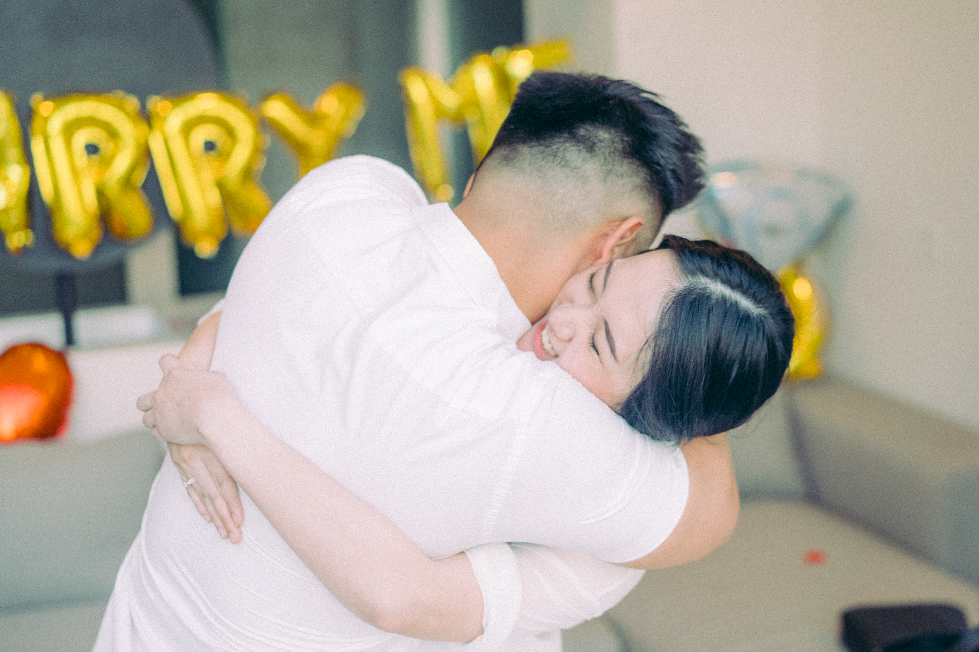 The couple hug each other in engagement proposal photography session