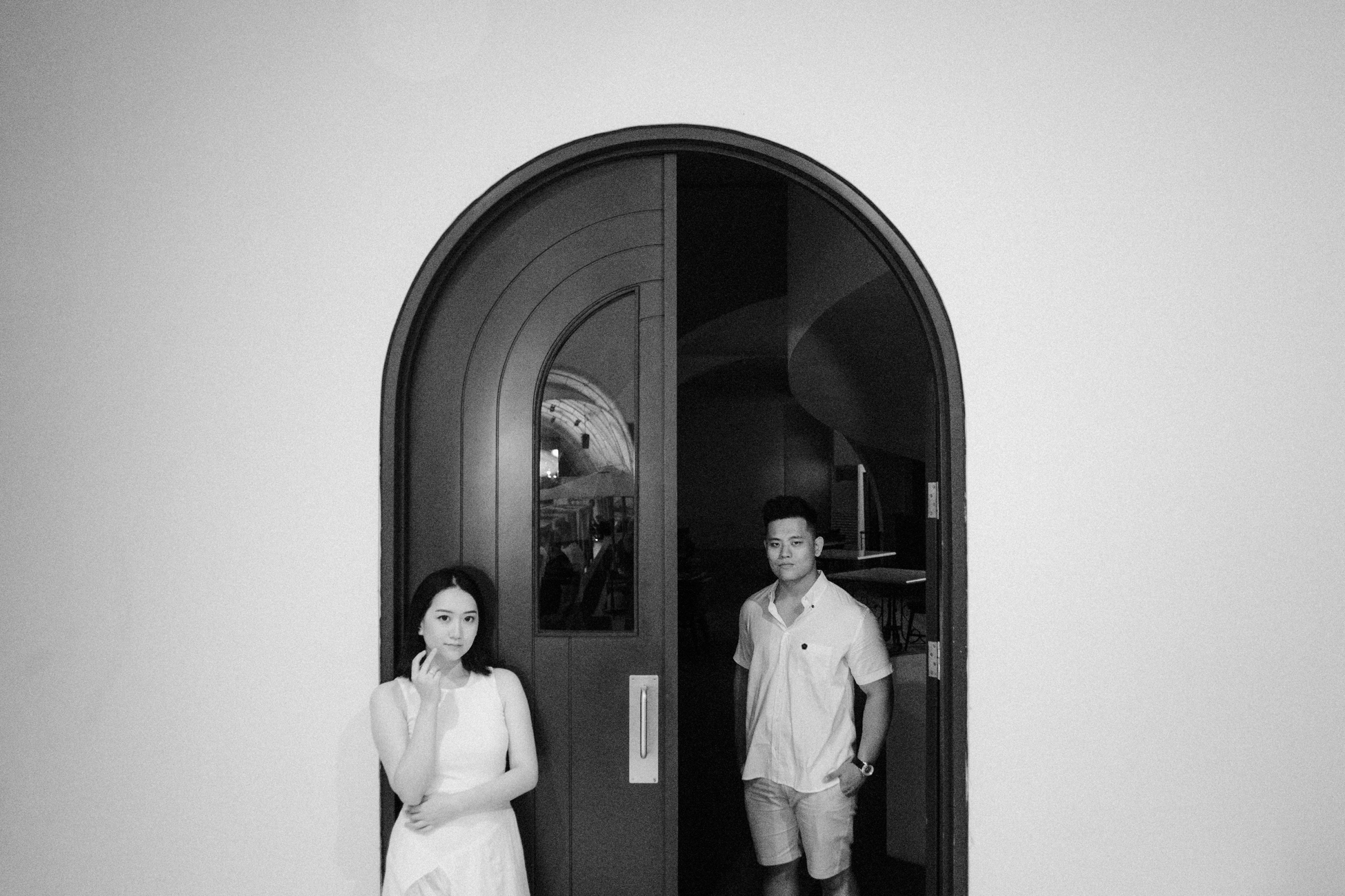 Pre-wedding photo session in front of the door in black and white