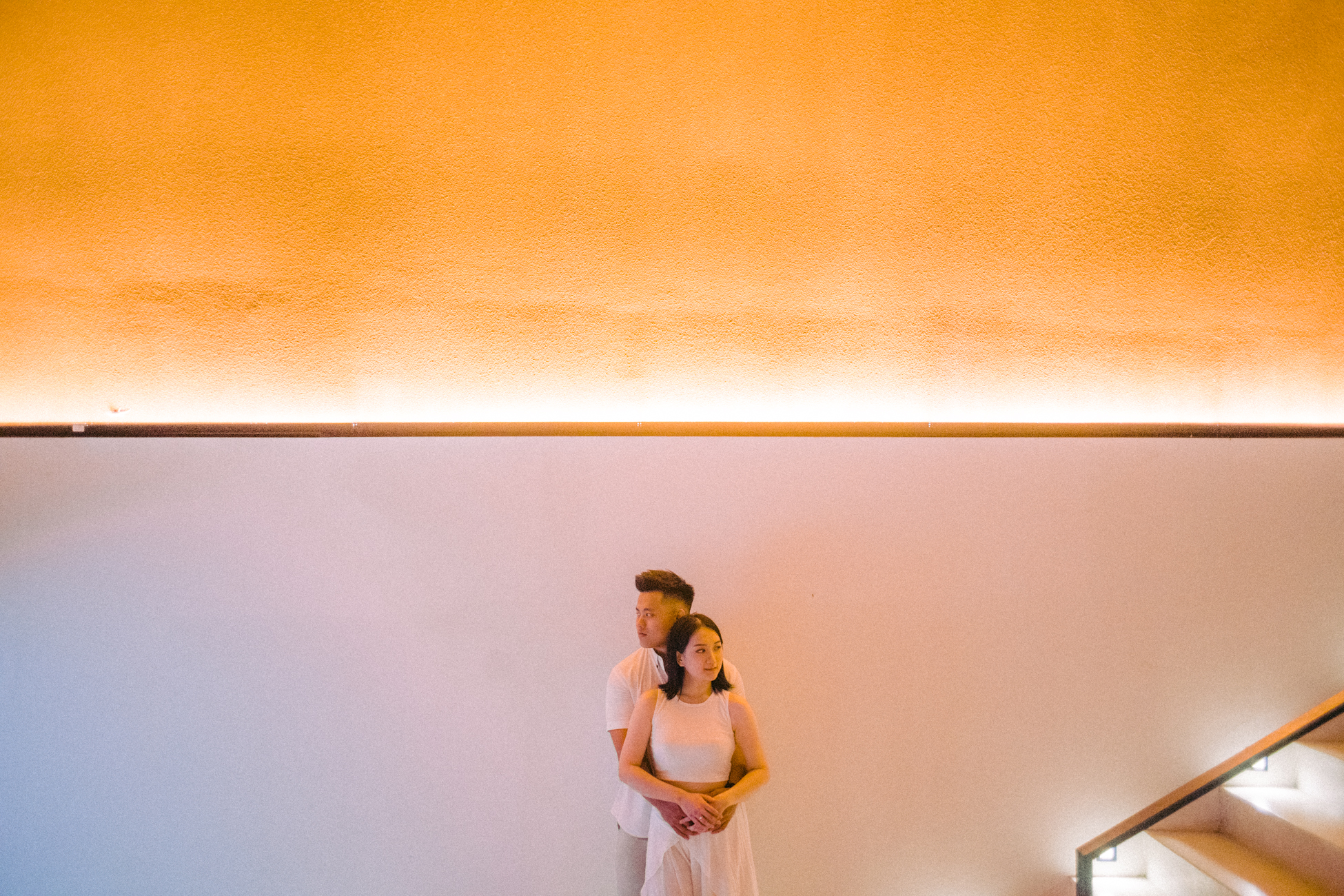 The couple standing in the entrance lobby at Cafe del Mar Bali in warm light