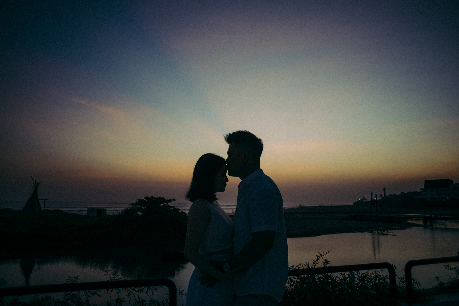 The man kiss her forehead at sunset in Canggu
